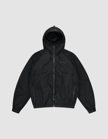The LIVE FAST DIE YOUNG Live Fast Nylon Jacket is a black, oversized zip-up windbreaker with long sleeves, hood, Stehkragen, and side pockets, shown against a plain light gray background. | plain