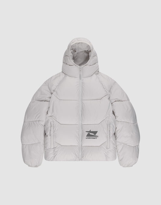 The Live Fast Puffer Jacket by LIVE FAST DIE YOUNG is a light gray, oversized puffer with a hood, front zipper, two side pockets, and a black graphic plus "LIVE FAST" in reflective print on the lower left.