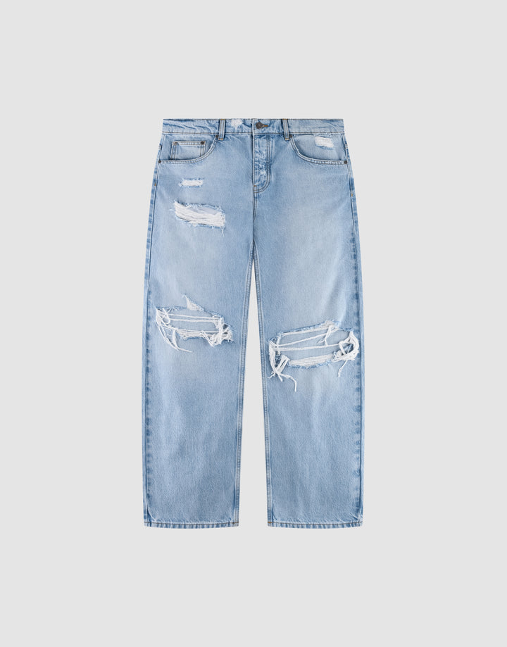 The LFDY Distressed Baggy Denim from LIVE FAST DIE YOUNG are light blue, high-waisted jeans with wide straight legs, heavy distressing, large frayed knee holes, thigh rips, and made from 100% Baumwolle for comfort. | plain
