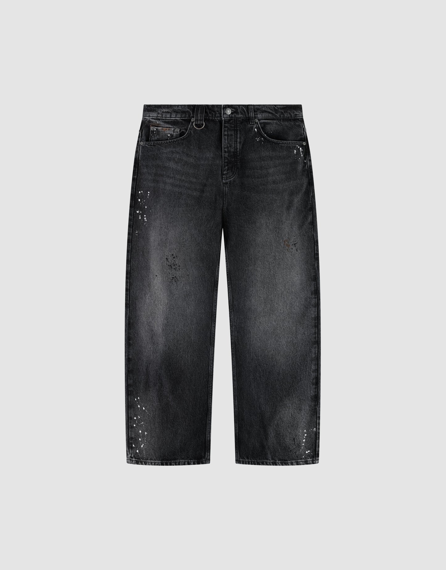 The LIVE FAST DIE YOUNG LFDY Baggy Denim is a pair of black jeans with a wide straight leg, baggy fit, faded wash, and white paint splatters, shown on a plain light gray background.