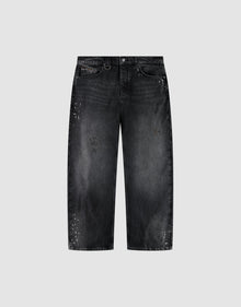 The LIVE FAST DIE YOUNG LFDY Baggy Denim is a pair of black jeans with a wide straight leg, baggy fit, faded wash, and white paint splatters, shown on a plain light gray background. | plain
