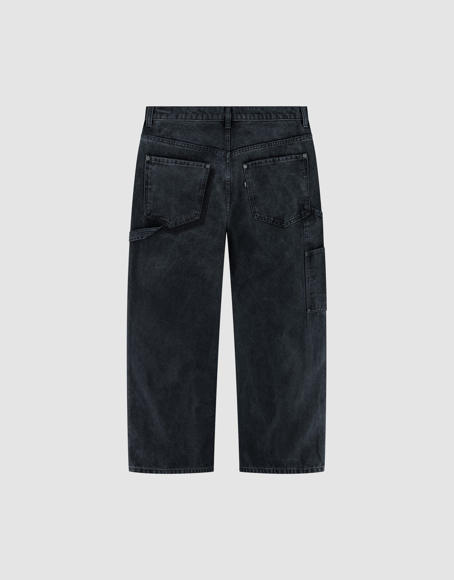 Back view of LFDY Carpenter Pants by LIVE FAST DIE YOUNG in black faded denim with a baggy fit, classic carpenter style, two large back pockets, and a side utility pocket, shown against a light gray background.