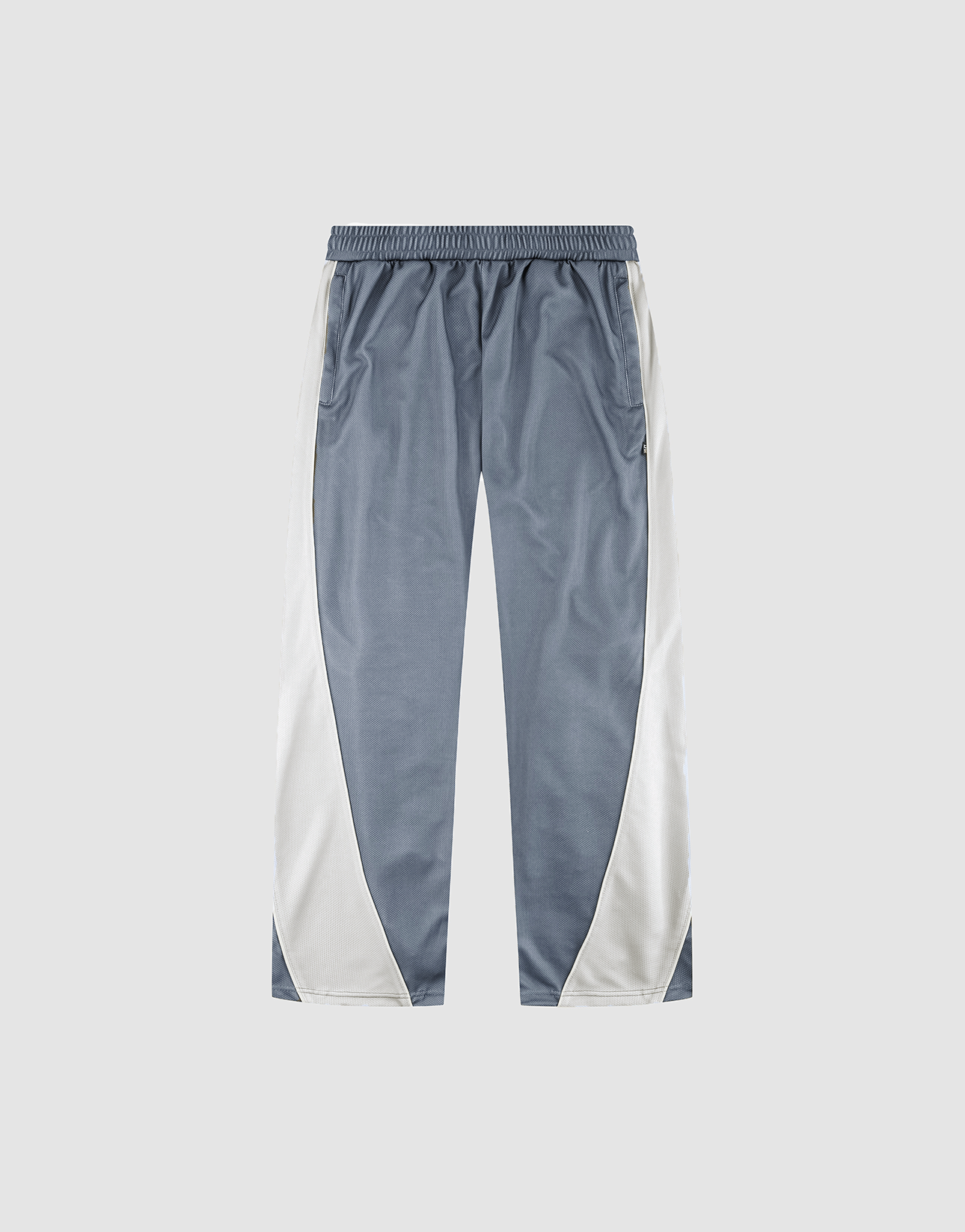 The LFDY DY Trackpants by LIVE FAST DIE YOUNG are wide fit, with a blue-gray center, white side panels, elastic waistband, and straight legs in polyester, shown on a light gray background.