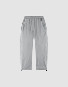 The LFDY Ripstop Trackpants by LIVE FAST DIE YOUNG feature light gray nylon, a wide elastic waistband, side pockets, adjustable ankle drawstrings, and a white "LUV IS RAGE" silicone logo on the upper left thigh for a modern look. | plain