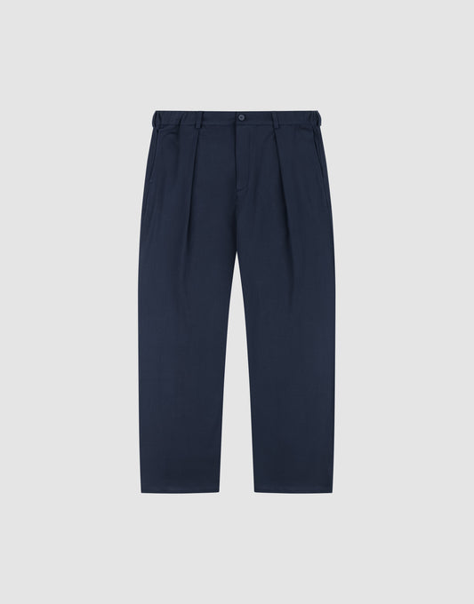 LIVE FAST DIE YOUNG Wide Casual Pants in navy blue with pleats, wide fit and straight leg, belt loops, side pockets, and button waistband, shown on a plain light grey background. | plain