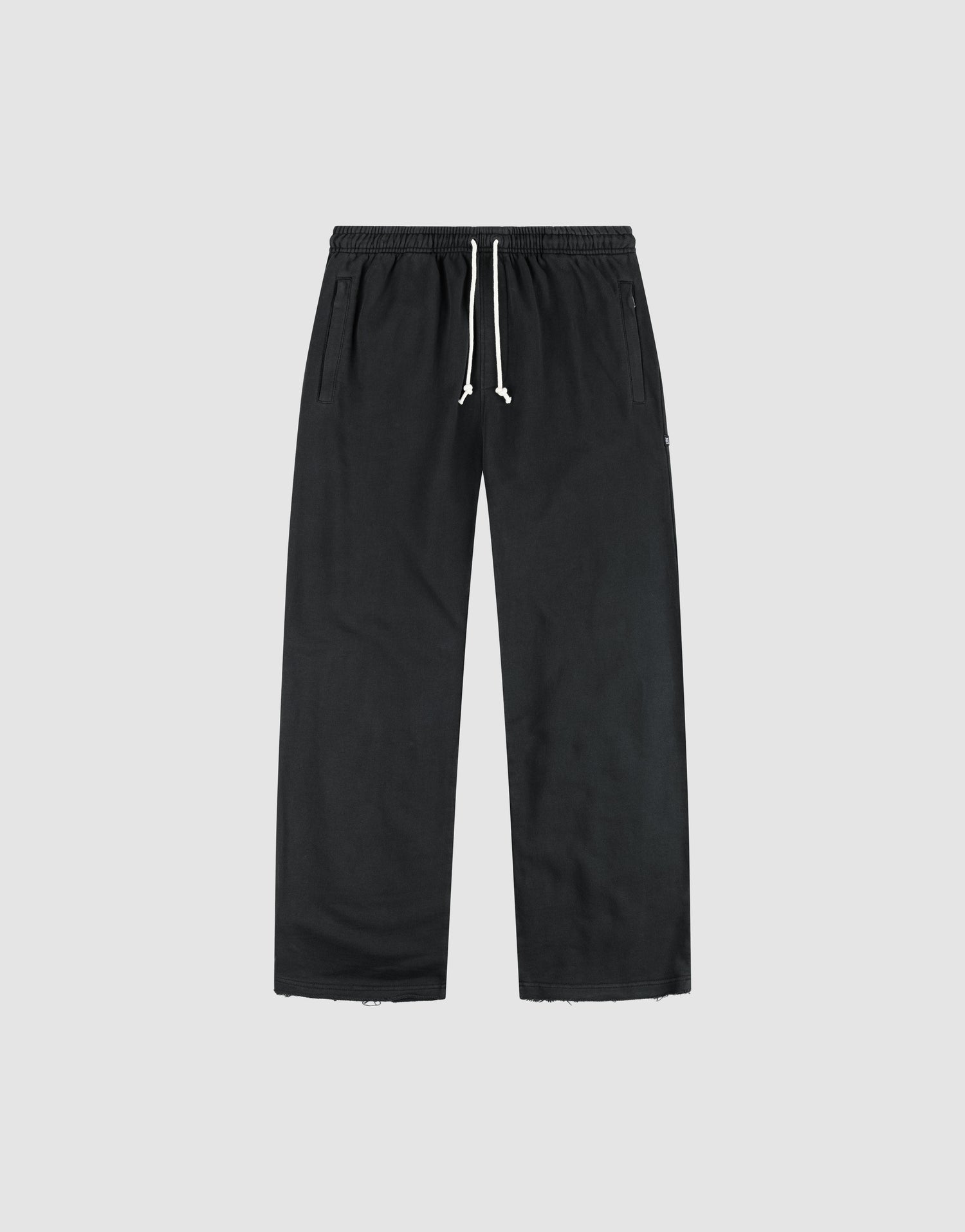 The LFDY Lightweight Jogger by LIVE FAST DIE YOUNG features a wide fit in soft French Terry, with an elastic waistband, white drawstring, and side pockets, shown flat on a light gray background. | plain
