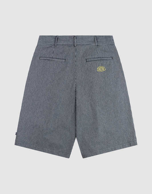 Back view of LFDY Twill Shorts by LIVE FAST DIE YOUNG in black and white pinstripes, featuring wide straight legs, belt loops, two back welt pockets, a yellow-black logo patch above the right pocket, and crafted from 100% cotton for comfort and style.