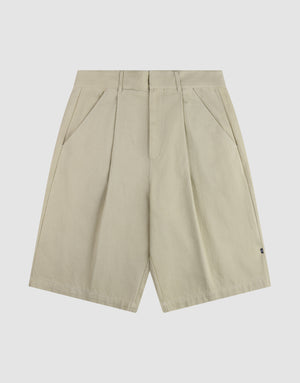 The LFDY Twill Shorts by LIVE FAST DIE YOUNG feature a beige color, front pleats, wide straight legs, belt loops, side pockets, and a relaxed oversized fit, shown on a plain white background. | plain