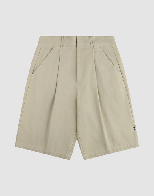 The LFDY Twill Shorts by LIVE FAST DIE YOUNG feature a beige color, front pleats, wide straight legs, belt loops, side pockets, and a relaxed oversized fit, shown on a plain white background. | plain