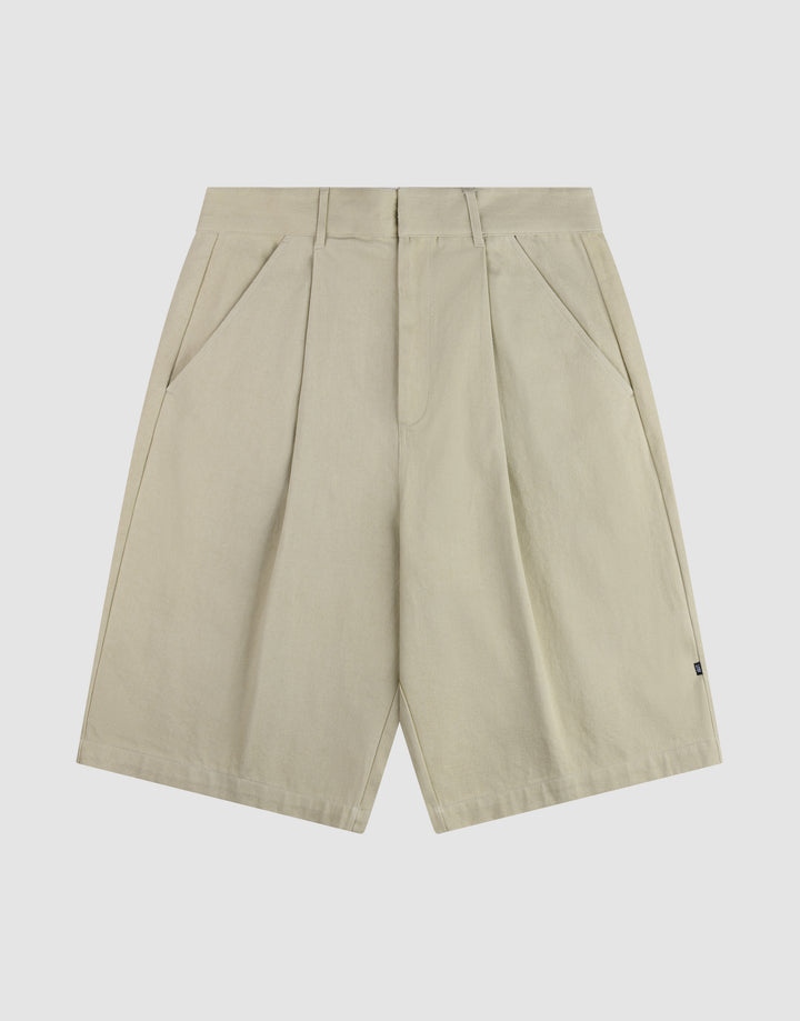The LFDY Twill Shorts by LIVE FAST DIE YOUNG feature a beige color, front pleats, wide straight legs, belt loops, side pockets, and a relaxed oversized fit, shown on a plain white background. | plain