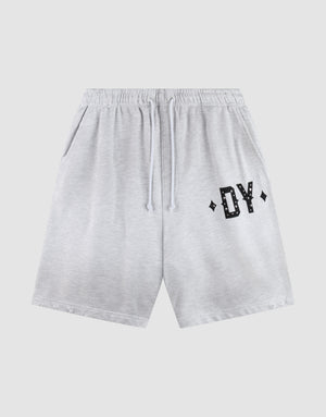 The DY Rivet Shorts by LIVE FAST DIE YOUNG feature a light gray color, elastic waistband with drawstring, side pockets, and black DY lettering with diamond accents. Made from 100% Baumwolle in an Oversize Fit for maximum comfort. | plain