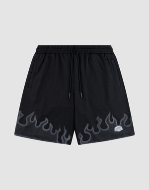 LIVE FAST DIE YOUNG Burning Mesh Shorts: black athletic shorts with elastic waistband, drawstring, gray flame print along the bottom, and a small white rectangular patch on the left leg. Plain light gray background. | plain