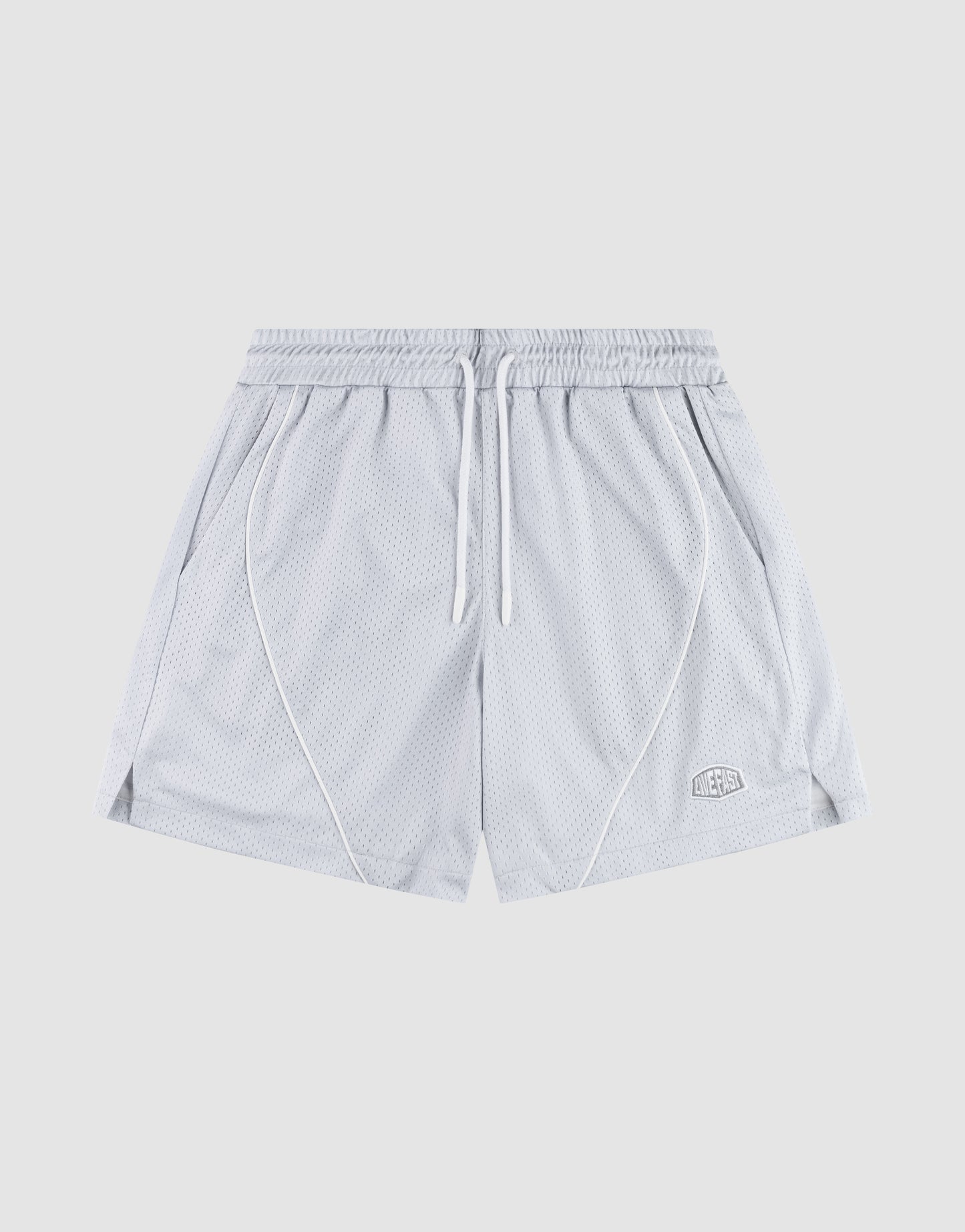 The LFDY Piping Mesh Shorts by LIVE FAST DIE YOUNG feature light gray polyester mesh, an elastic waistband with white drawstring, side pockets, front seam piping, a logo patch on the lower left leg, and a regular fit. Background is plain light gray.