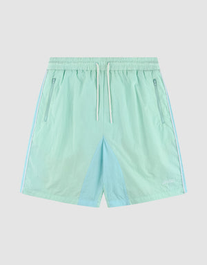 LIVE FAST DIE YOUNG Beach Shorts in light blue and mint green, color-blocked with elastic waistband, white drawstring, side zip pockets, and a small white logo on the lower left leg. Regular fit. Laid flat on a white background. | plain