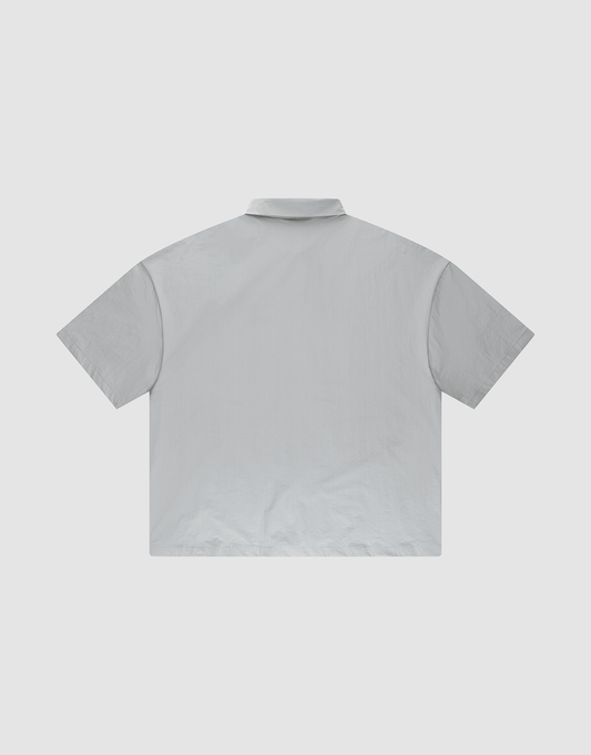 The LFDY Ripstop Shirt by LIVE FAST DIE YOUNG features a plain, light gray design with an oversized fit, shown from the back against a white background.
