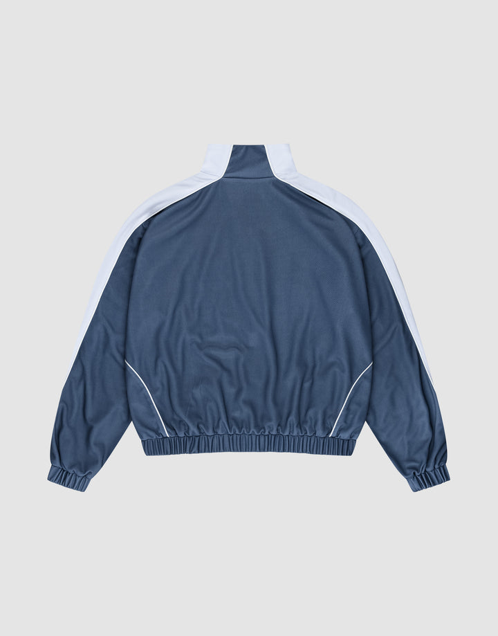The LIVE FAST DIE YOUNG LFDY Arch Trackjacket in blue polyester features white stripes on the shoulders and sleeves, an oversize fit, and elastic cuffs and hem, shown laid flat from the back on a light gray background.