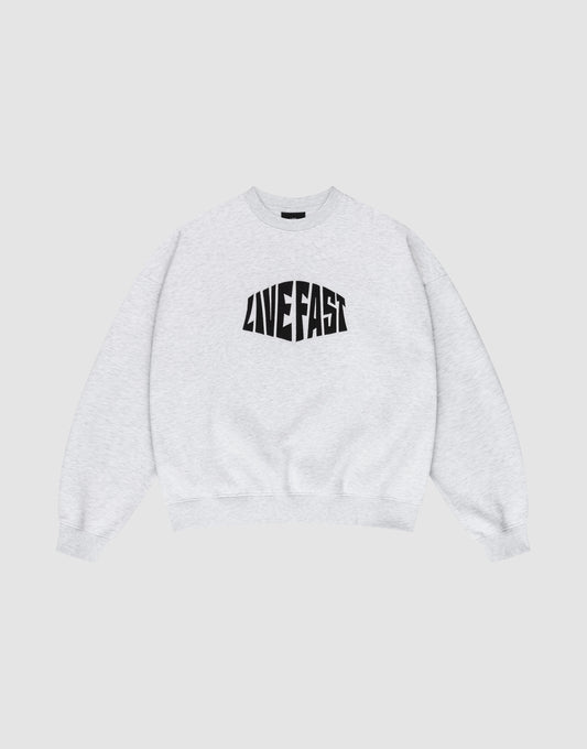 The LFDY Emblem Sweater by LIVE FAST DIE YOUNG is a light gray Oversize Fit crewneck with bold, black “LIVE FAST” lettering on the chest, shown laid flat on a white background. | plain