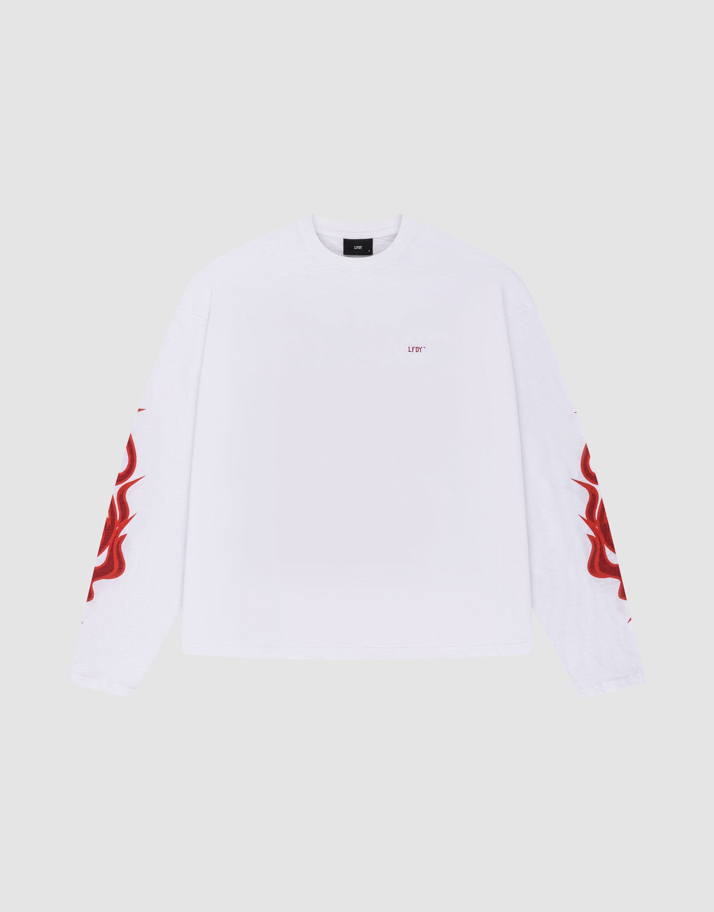 The LFDY We Walked Longsleeve by LIVE FAST DIE YOUNG is an oversized white 100% Baumwolle shirt with red flame sleeve graphics and small red UTY text on the left chest, shown against a plain light gray background.