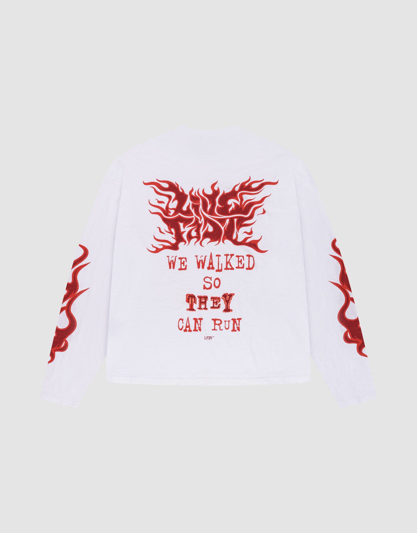 The LFDY We Walked Longsleeve by LIVE FAST DIE YOUNG is a white, 100% Baumwolle shirt with red flame graphics on the sleeves, a large flame back print, an Oversize Fit, and bold red "WE WALKED SO THEY CAN RUN" text on the back.