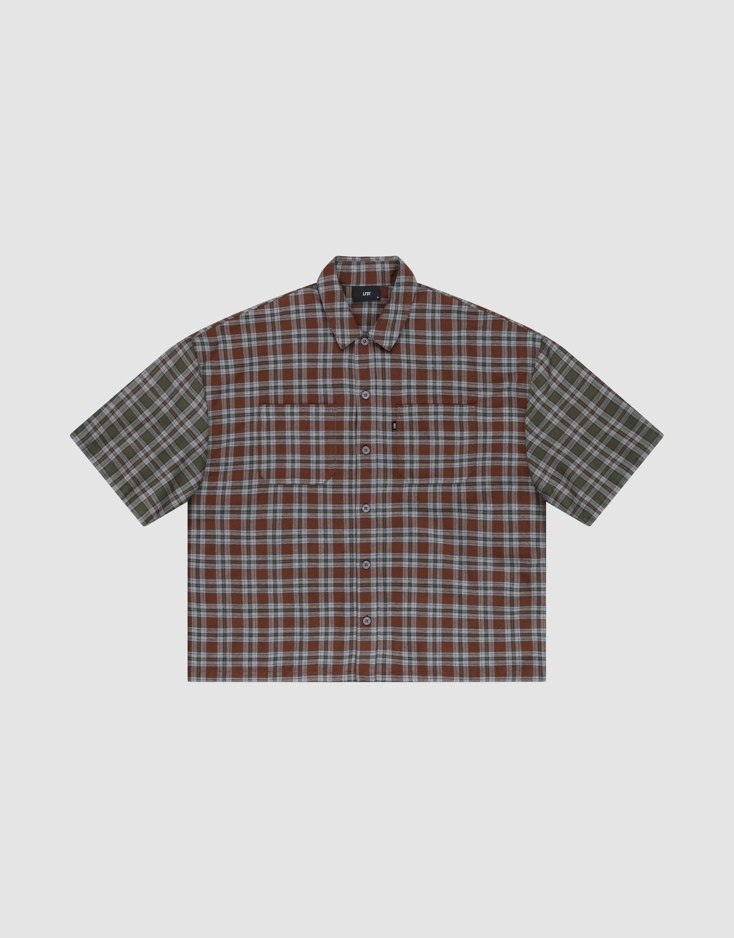 The LFDY Light Flannel by LIVE FAST DIE YOUNG is a short-sleeved, button-up shirt with brown, green, and white plaid, an oversize fit, left chest pocket, and is made from 100% Baumwolle. Shown against a plain light gray background.