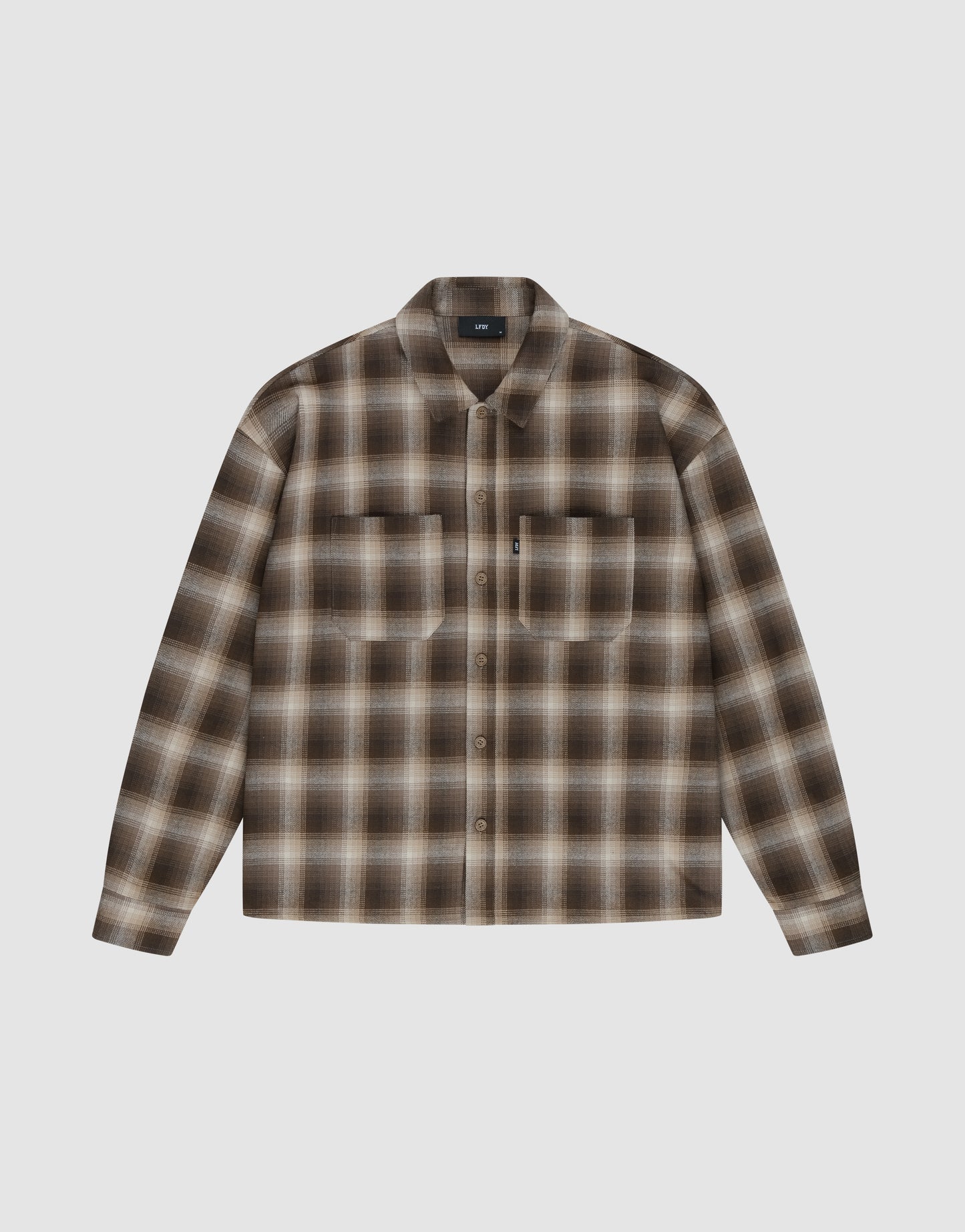 The LIVE FAST DIE YOUNG Vintage Flannel is a long-sleeve, button-up shirt with brown and beige plaid in vintage wash, featuring two chest pockets and a collar, shown on a white background.