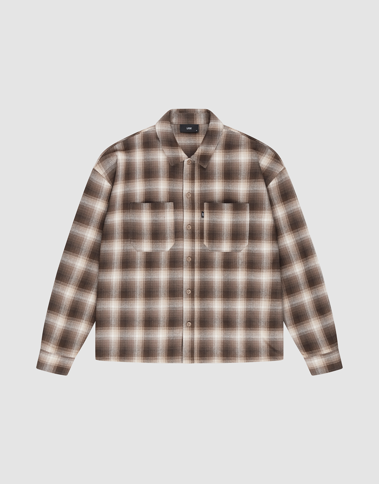 The Vintage Flannel by LIVE FAST DIE YOUNG features brown, beige, and white plaid, an oversized fit, two chest pockets, subtle branding, and is shown on a plain white background.