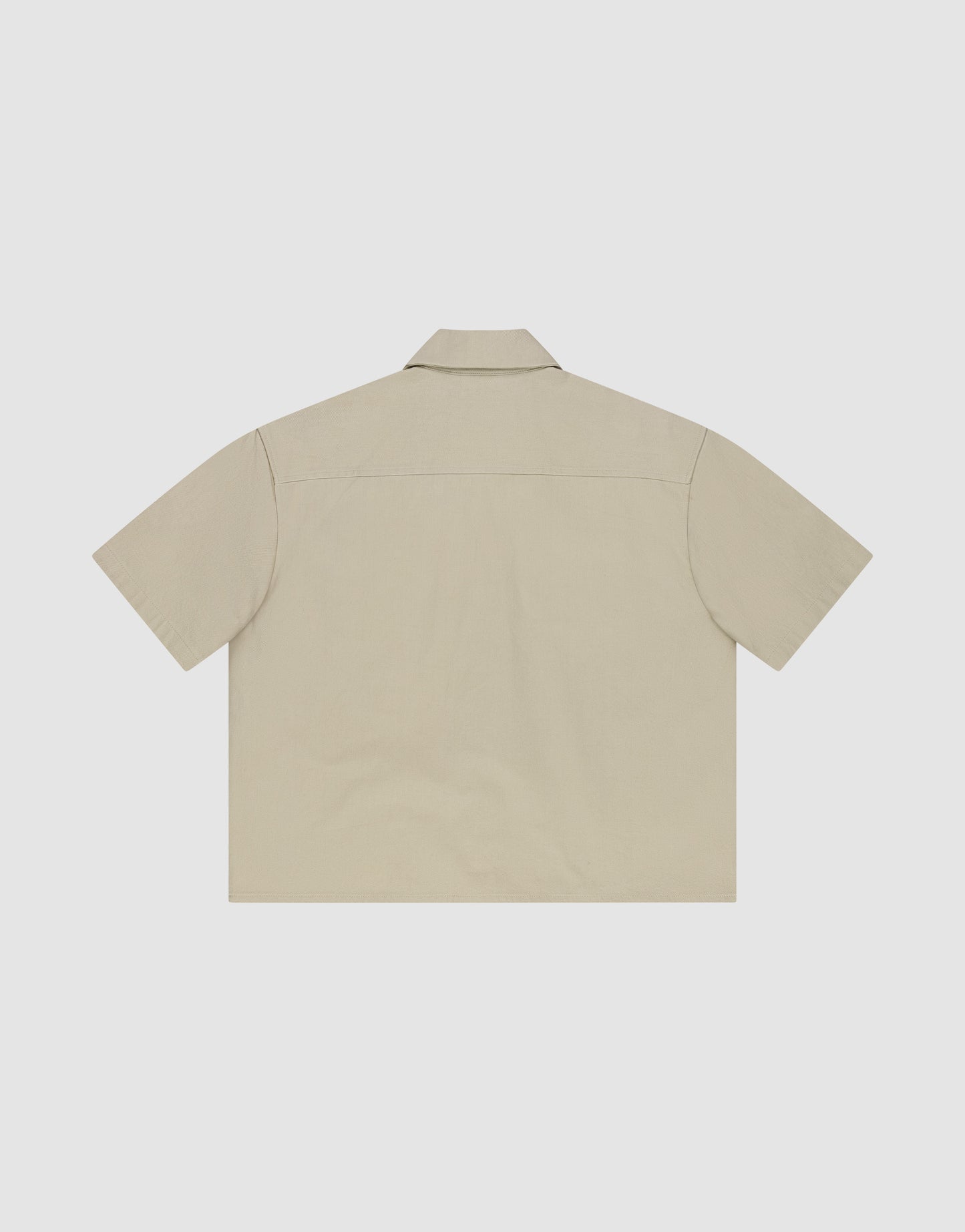 The LFDY Twill Shirt by LIVE FAST DIE YOUNG is a beige, short-sleeve shirt made from 100% Baumwolle, shown flat from the back with a classic collar and straight hem against a white background.