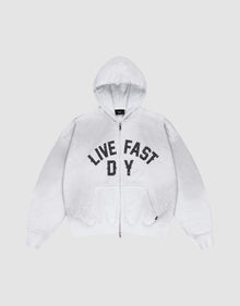 The Live Fast Rivet Hooded Zip by LIVE FAST DIE YOUNG is a light gray, oversize-fit hoodie with front pockets, a hood, black “LIVE FAST D Y” chest text, and unique hand-applied white paint splatters. Made from 100% Baumwolle. | plain