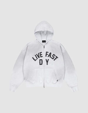 The Live Fast Rivet Hooded Zip by LIVE FAST DIE YOUNG is a light gray, oversize-fit hoodie with front pockets, a hood, black “LIVE FAST D Y” chest text, and unique hand-applied white paint splatters. Made from 100% Baumwolle. | plain