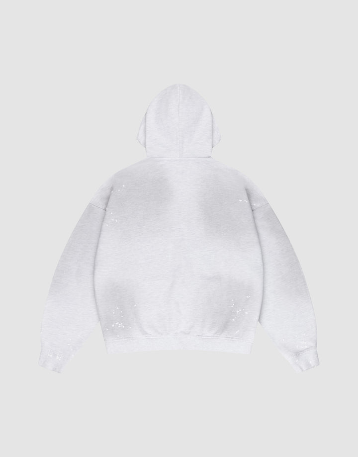 The LIVE FAST DIE YOUNG Live Fast Rivet Hooded Zip in light gray is laid flat, back up, on a matching background. It features an oversize fit and hand-applied spray effect with scattered white specks.
