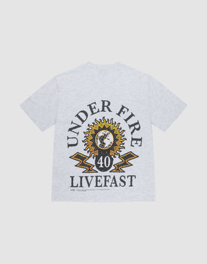 The LFDY Under Fire Tee by LIVE FAST DIE YOUNG is a light gray oversized cotton T-shirt with bold UNDER FIRE and LIVEFAST prints, yellow lightning, the number 40, and a sun-and-earth graphic on the back. | plain