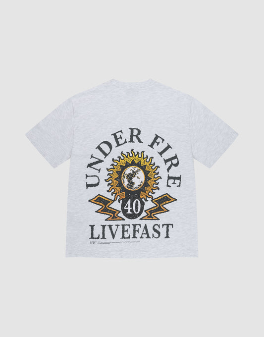The LFDY Under Fire Tee by LIVE FAST DIE YOUNG is a light gray oversized cotton T-shirt with bold UNDER FIRE and LIVEFAST prints, yellow lightning, the number 40, and a sun-and-earth graphic on the back. | plain