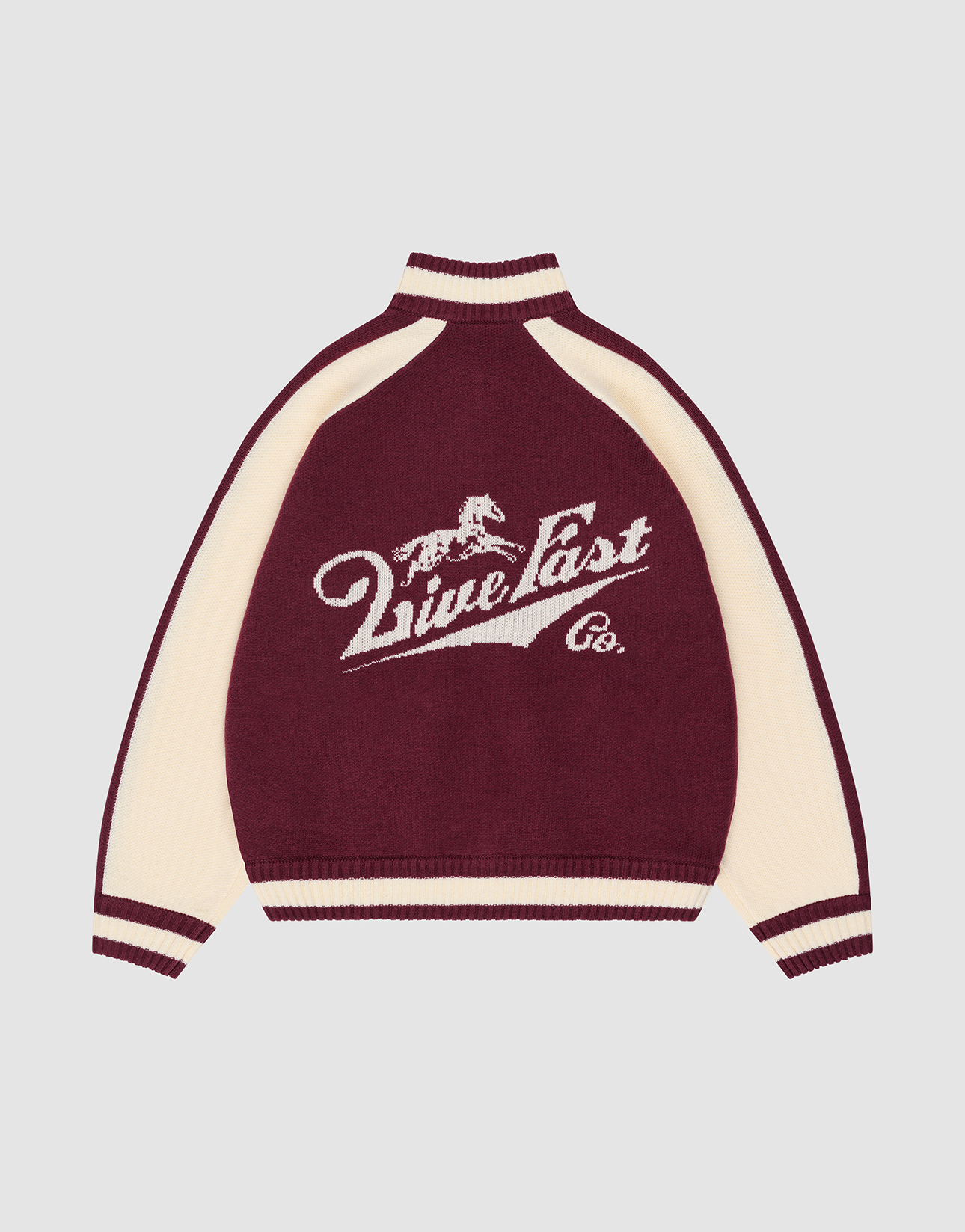 A maroon and cream Boxy Knit Zip Jacket by LIVE FAST DIE YOUNG, featuring long sleeves, a galloping horse intarsia, “Live Fast Co.” text on the back in white, and striped cuffs, collar, and hem for a bold yet classic style.