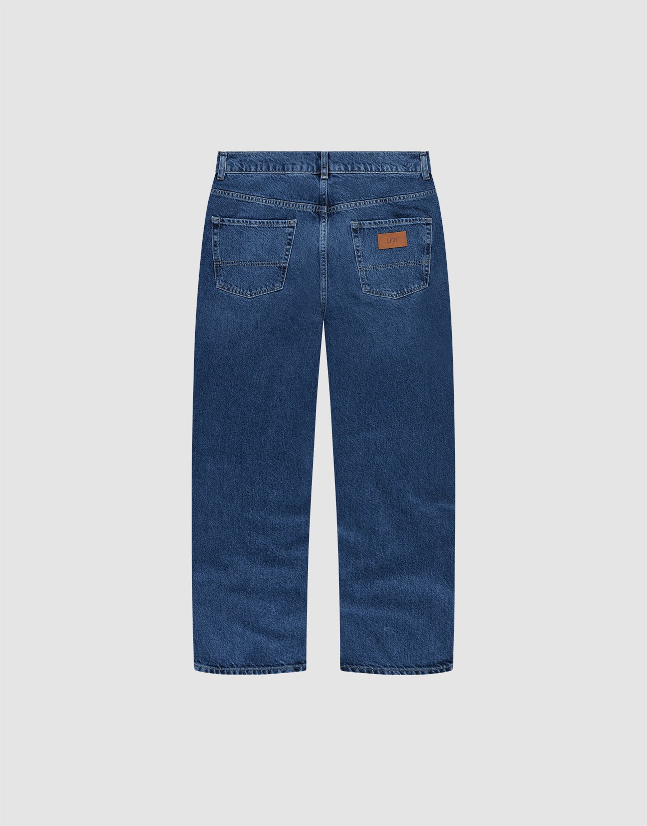 A pair of Wide Denim jeans by LIVE FAST DIE YOUNG, shown from the back with two rear pockets, visible stitching, a brown leather patch on the right pocket, and made of 100% Baumwolle against a plain light gray background.