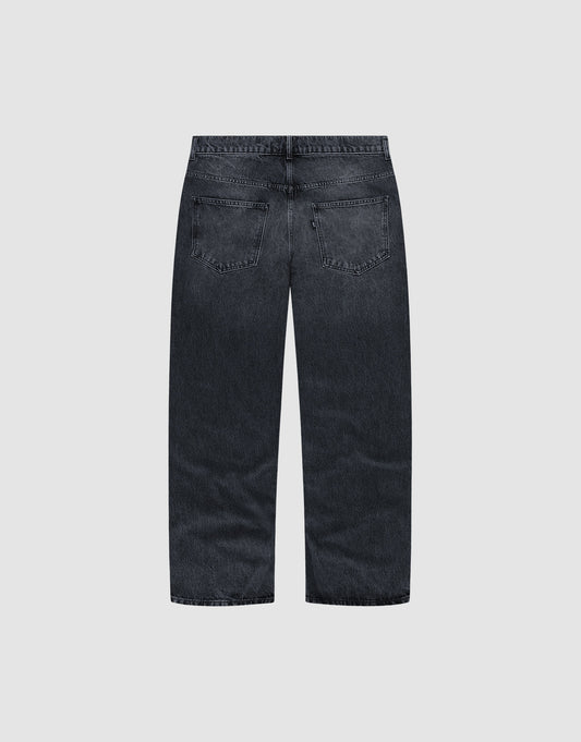 Back view of the LFDY Baggy Denim by LIVE FAST DIE YOUNG, crafted from 100% Baumwolle in dark-wash with a wide straight leg, two back pockets, no visible distressing, shown on a plain light gray background.