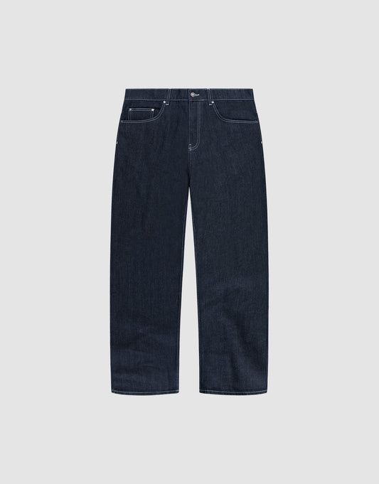 The LFDY Baggy Denim by LIVE FAST DIE YOUNG features dark blue raw-denim, a baggy straight-leg fit, white stitching, five pockets, and button closure in 100% cotton. Shown on a plain light grey background. | plain