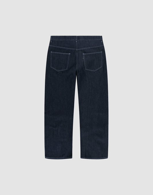 LFDY Baggy Denim by LIVE FAST DIE YOUNG in dark blue raw denim, shown from the back with wide straight legs, white stitching, and two rear pockets. Made from 100% cotton and displayed on a plain light gray background.
