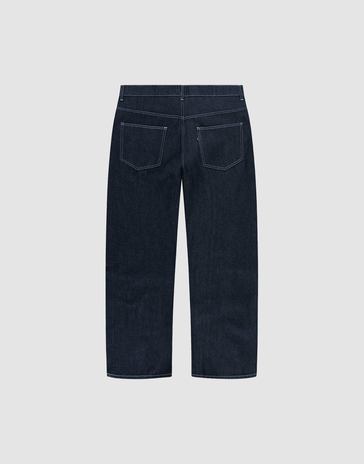 LFDY Baggy Denim by LIVE FAST DIE YOUNG in dark blue raw denim, shown from the back with wide straight legs, white stitching, and two rear pockets. Made from 100% cotton and displayed on a plain light gray background.