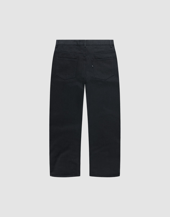 Back view of LIVE FAST DIE YOUNG's LFDY Baggy Denim in black, straight-leg and baggy fit, with two back pockets and belt loops, displayed against a plain light background.