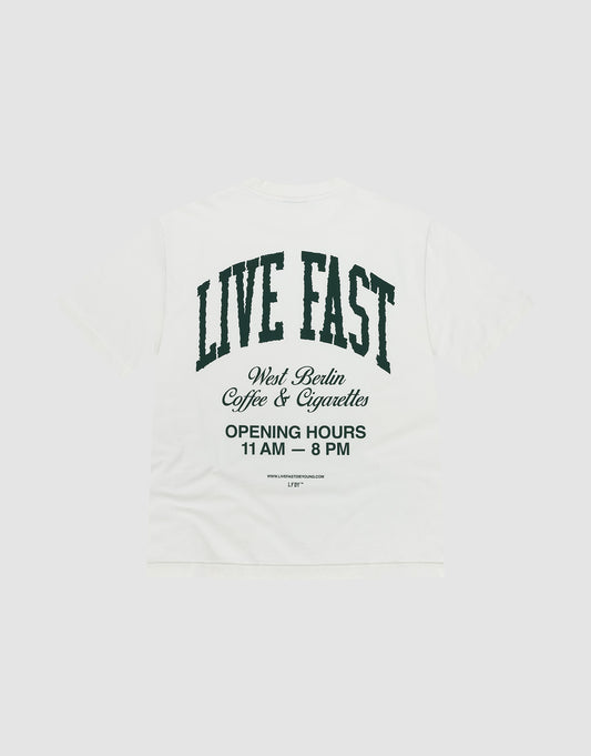 The Live Fast Coffee Tee by LIVE FAST DIE YOUNG is a white oversized T-shirt made from 100% Baumwolle, featuring bold front and back prints. Large black text on the back reads "LIVE FAST" with West Berlin Coffee & Cigarettes and opening hours below. | plain