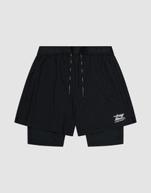 The LIVE FAST DIE YOUNG Live Fast Performance Running Shorts feature an overlapping design with built-in tights, elastic waistband with drawstrings, and a small white Live Fast Branding logo on the lower left leg, shown on a plain light gray background.| plain