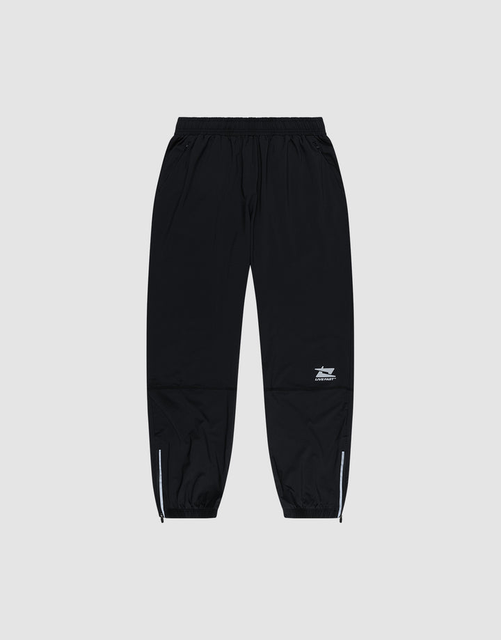 LIVE FAST DIE YOUNG’s Live Fast Performance Running Pants feature a black design with an elastic waistband, cuffed and zippered ankles, plus a small white logo on the left thigh, shown against a plain light gray background. | plain