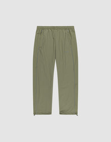 The Live Fast Trackpants by LIVE FAST DIE YOUNG are light olive green, wide-fit, lightweight pants with an elastic waistband, side pockets, subtle seam details, ankle zippers, and a reflective logo print. Shown on a plain white background. | plain