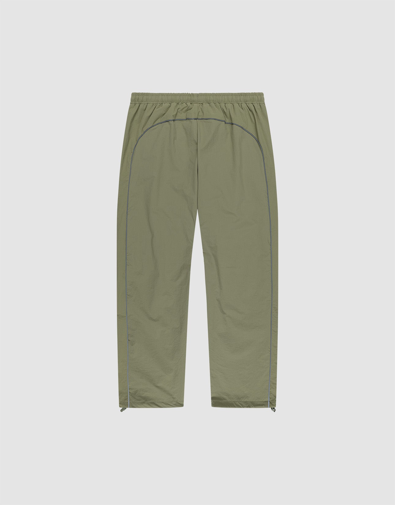 The Live Fast Trackpants by LIVE FAST DIE YOUNG feature a light olive green color, elastic waistband, straight-leg wide fit, blue side piping, reflective logo print, and small side zippers at the leg openings on a light background.