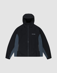 The LIVE FAST DIE YOUNG Basic Shell Jacket features an oversize fit, black hood, dark gray panels, front zipper, side pockets, and "LMC PDRF" in small white letters on the left chest. Shown laid flat on a light gray background. | plain
