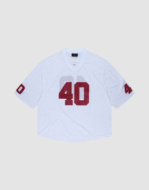 The LFDY Mesh Jersey by LIVE FAST DIE YOUNG is a white polyester football jersey with an oversize fit, short sleeves, and bold red number 40 on the front and sleeves. It features a V-neck collar and is shown on a light gray background. | plain