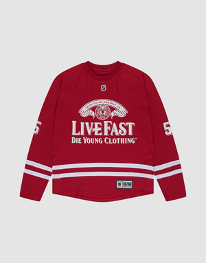 The LFDY Hockey Jersey by LIVE FAST DIE YOUNG is a red, oversized polyester long-sleeve shirt with white stripes, "LIVE FAST DIE YOUNG CLOTHING" on the front, number 56 on the sleeves, and an NHL-style collar patch. | plain