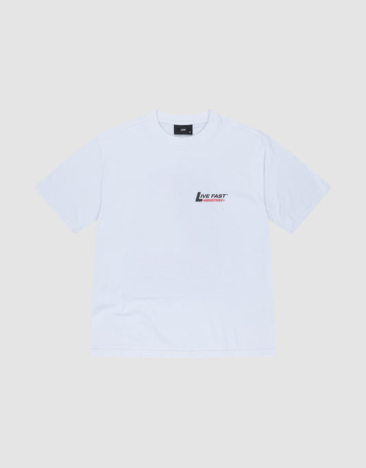 The LFDY Industries Tee by LIVE FAST DIE YOUNG is a plain white oversized short-sleeve t-shirt, made from 100% cotton, featuring a small black and red Live Fast logo and text on the left chest, shown on a light grey background.