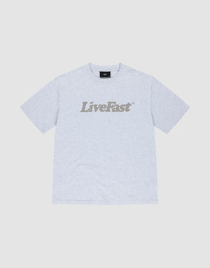 The Basic Tee by LIVE FAST DIE YOUNG is a light gray oversized cotton t-shirt with "Live Fast" boldly printed in dark gray across the chest, shown against a white background. | plain