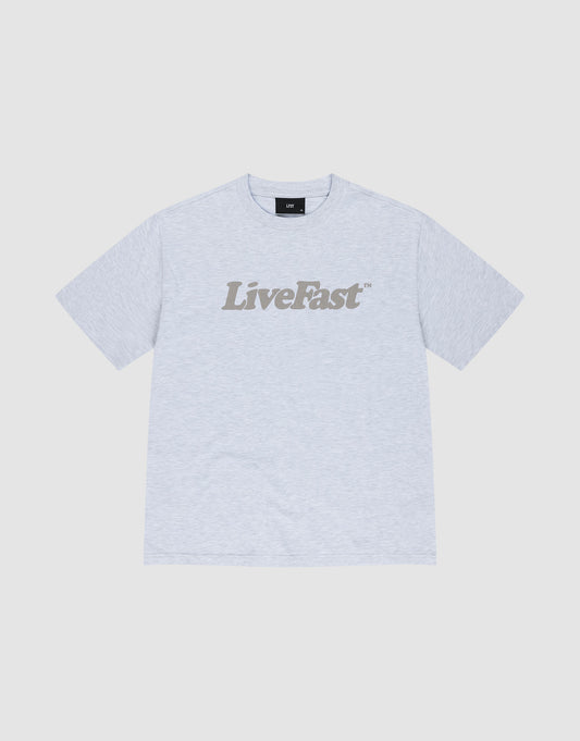 The Basic Tee by LIVE FAST DIE YOUNG is a light gray oversized cotton t-shirt with "Live Fast" boldly printed in dark gray across the chest, shown against a white background. | plain